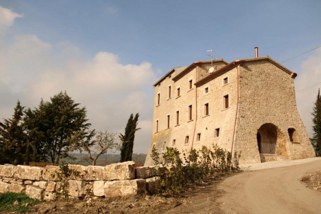 un gran edificio de piedra al lado de una carretera en B&B Il Casone di Drusa, en San Marco dei Cavoti