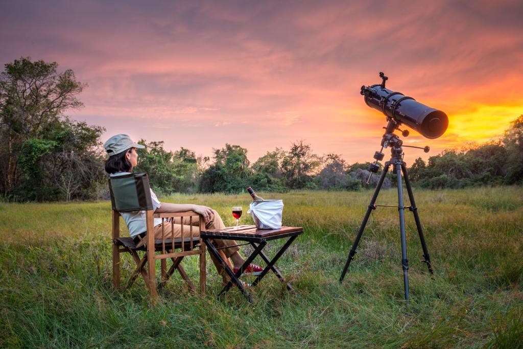 a woman sitting in a chair in front of a camera at Mahoora Wilpattu - by Eco Team in Wilpattu
