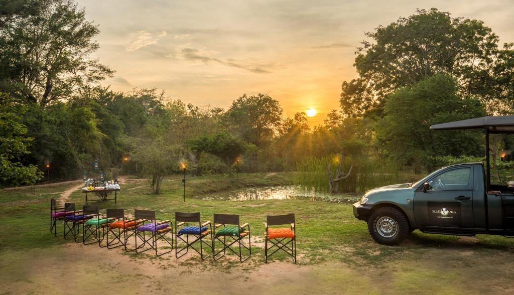 a truck parked next to a group of chairs at Mahoora Wilpattu - by Eco Team in Wilpattu