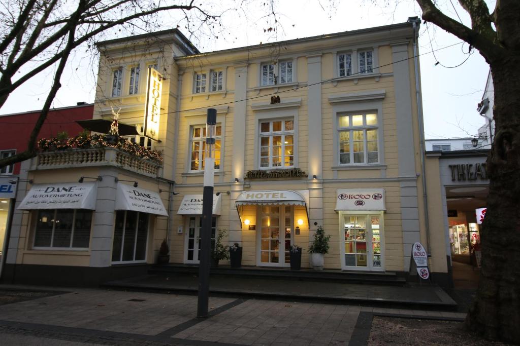 a large white building on a city street at Hotel zum Adler - Superior in Bonn