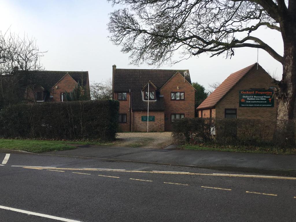 two brick houses on the side of a road at Simpson's Apartments in Daventry