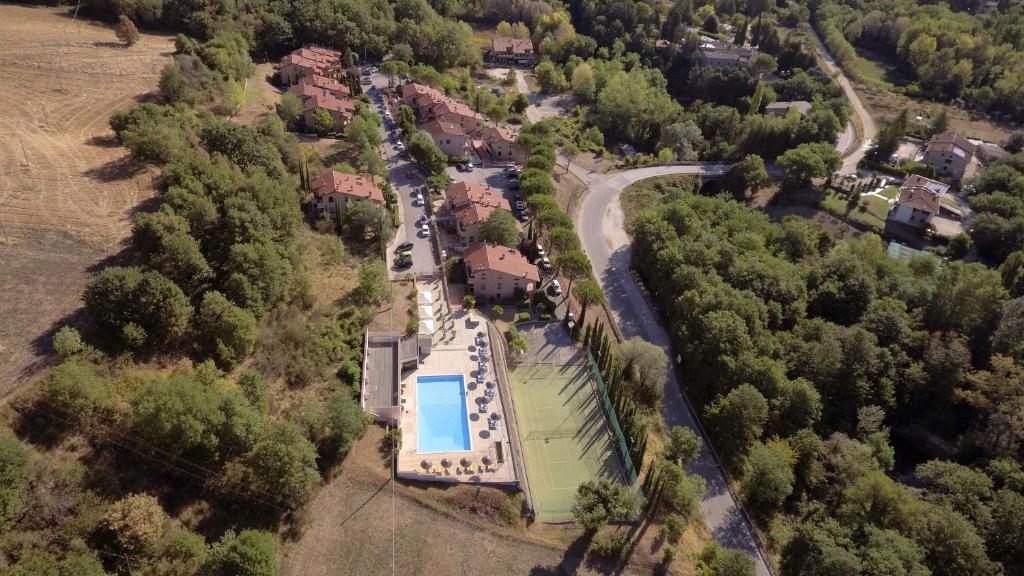 an overhead view of a house with a swimming pool at Carpediem Assisi Living Club in Piano Delle Pieve