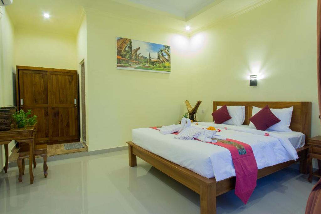 Postel nebo postele na pokoji v ubytování Vinayaka Ubud