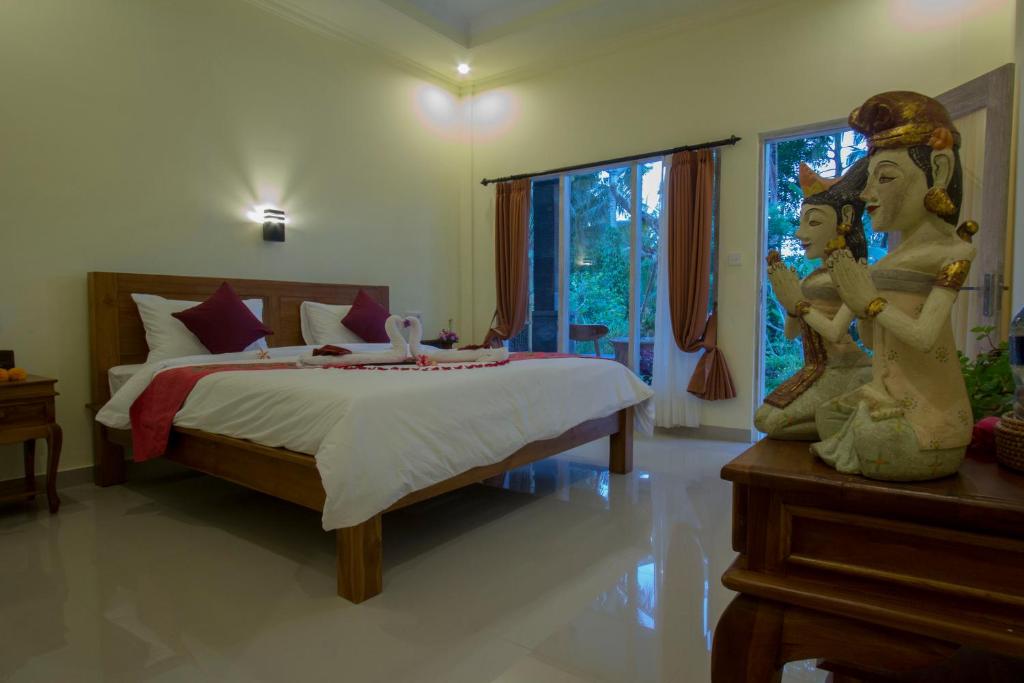 Postel nebo postele na pokoji v ubytování Vinayaka Ubud