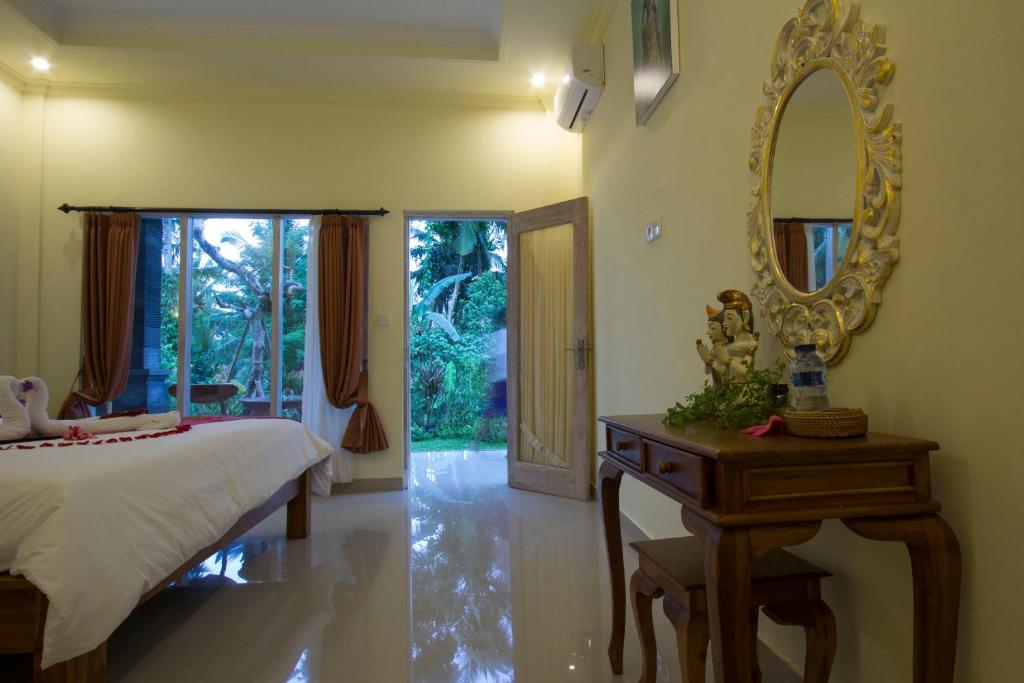 Postel nebo postele na pokoji v ubytování Vinayaka Ubud