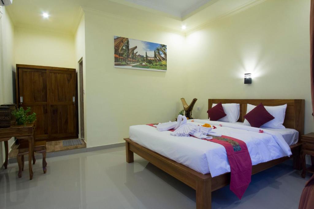Postel nebo postele na pokoji v ubytování Vinayaka Ubud