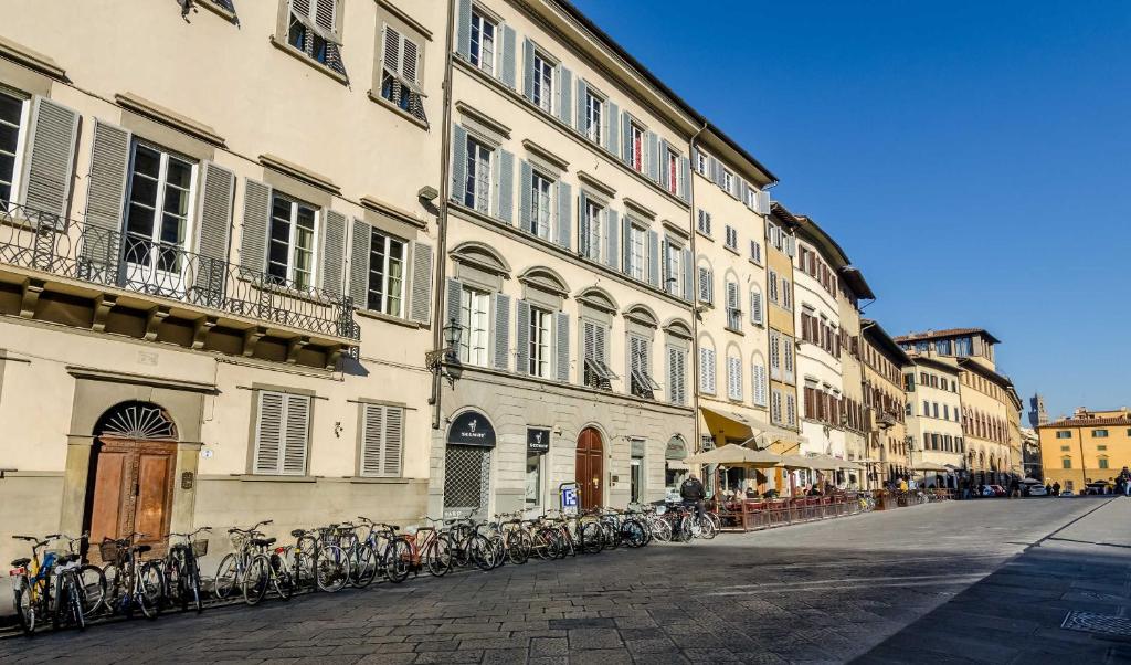 a city street with a bunch of bicycles parked in front of it at Soggiorno Pitti in Florence