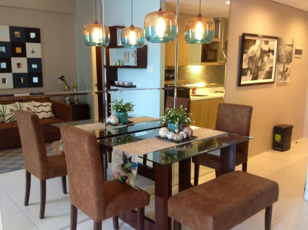 a dining room with a table and some chairs at Luxurious Family Room Pico de Loro in Nasugbu