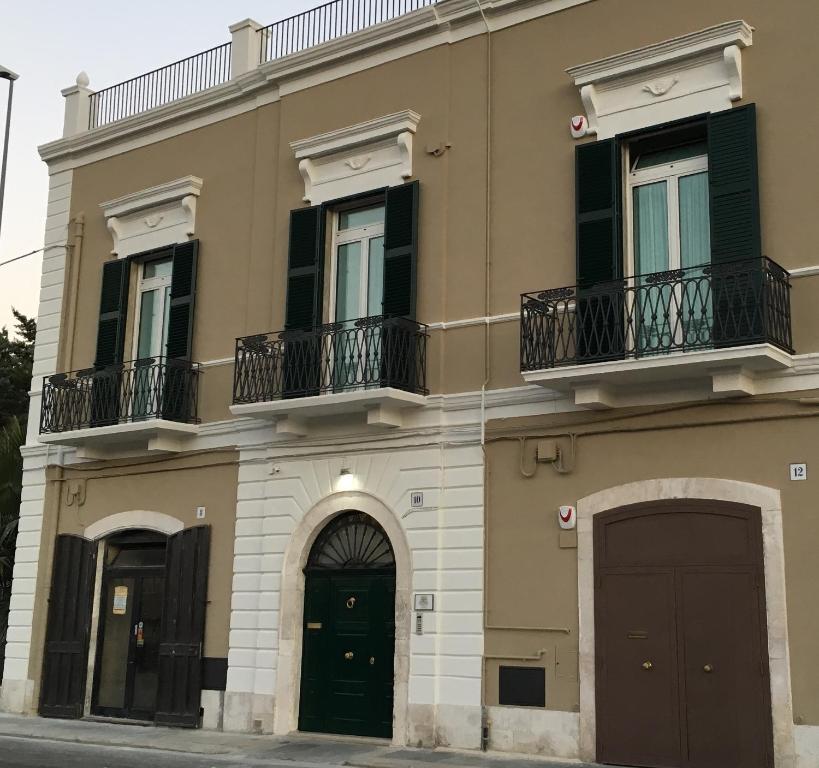 a building with two doors and two balconies at La casa nel sole - Boutique B&B in Bari