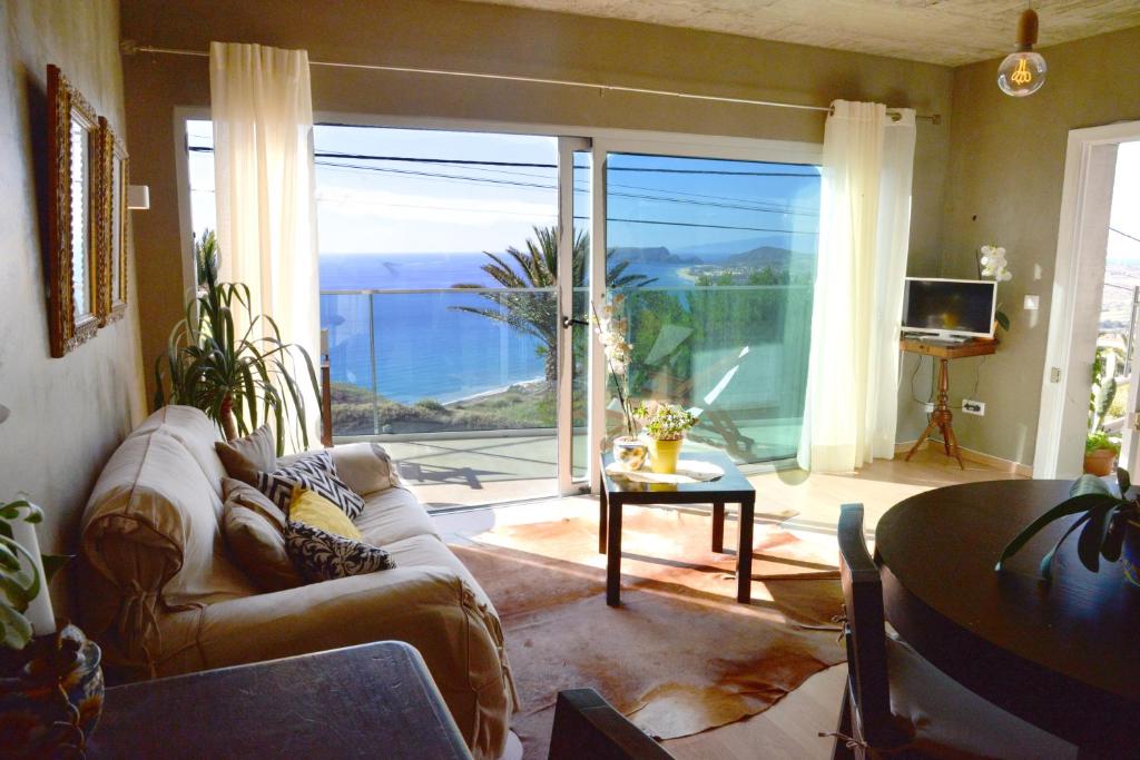 a living room with a couch and a view of the ocean at Porto Santo Balcony View House in Porto Santo