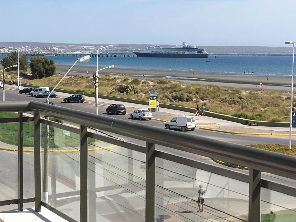 a view of a highway with cars and a cruise ship at Edificio Soles in Puerto Madryn