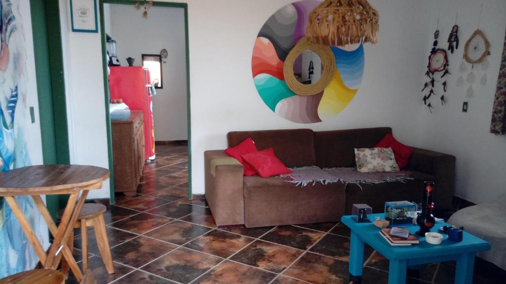 a living room with a couch and a table at Sumé Hostel in São Thomé das Letras