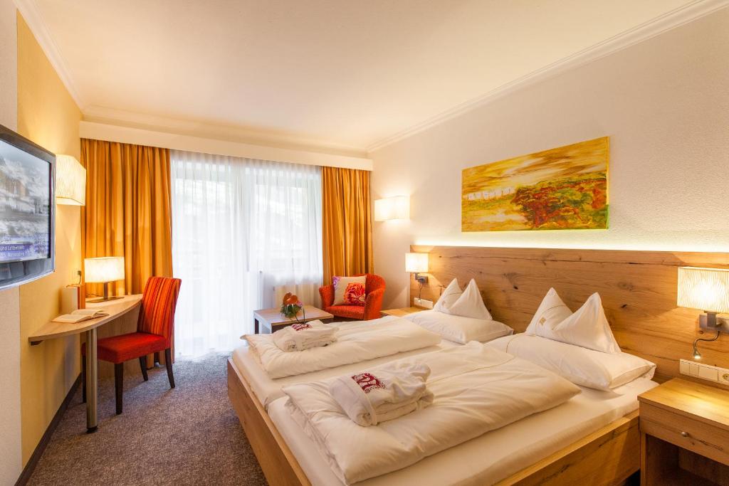 Postel nebo postele na pokoji v ubytování Hotel Madeleine