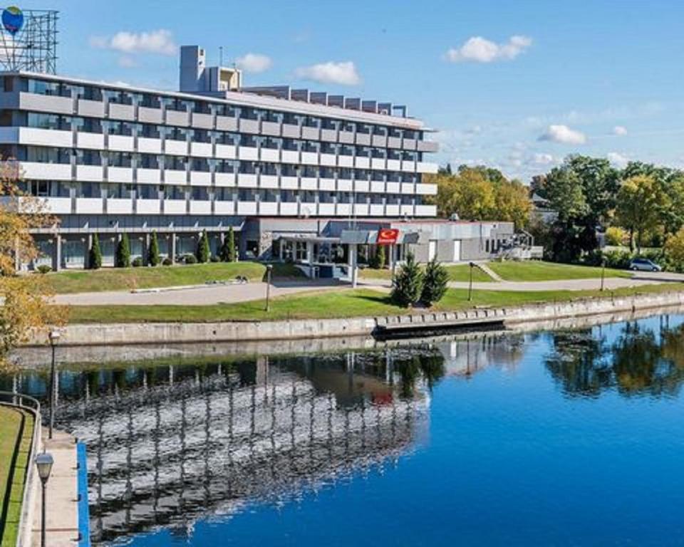 a large building next to a body of water at Econolodge Smiths Falls in Smiths Falls