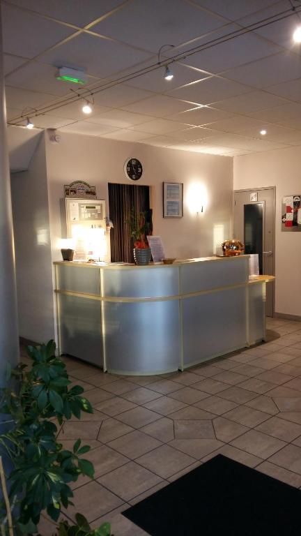 a lobby with a reception desk in a building at Les Balcons Du Velay in Monistrol-sur-Loire