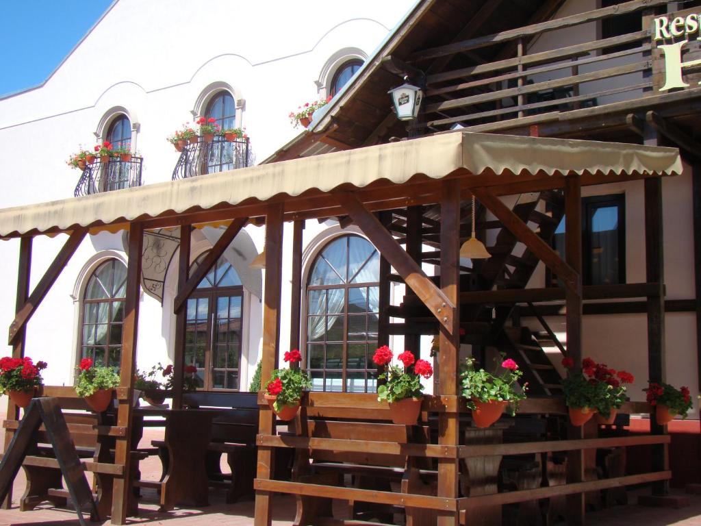 a wooden gazebo in front of a building at Casa Hora in Suceava