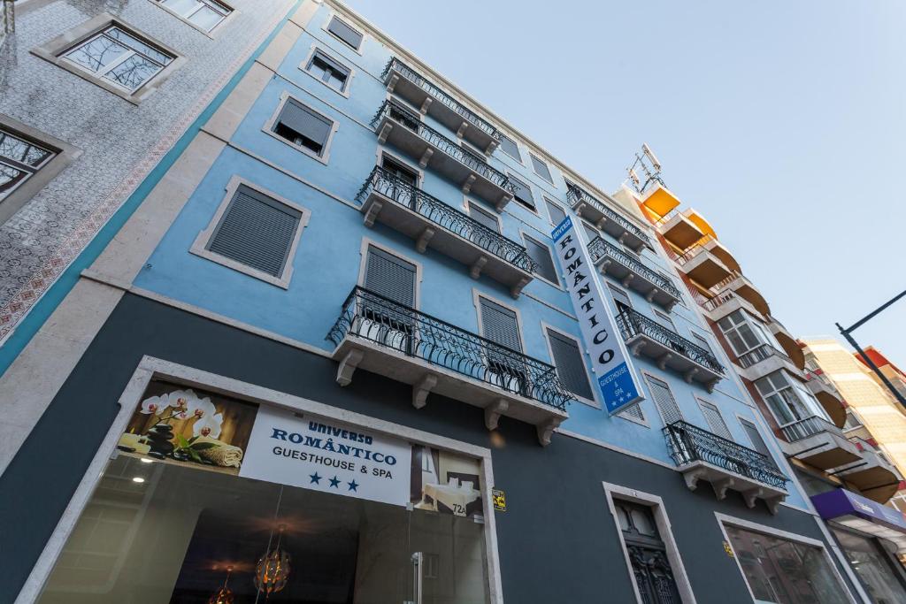 a blue building with a sign in front of it at Universo Romantico in Lisbon