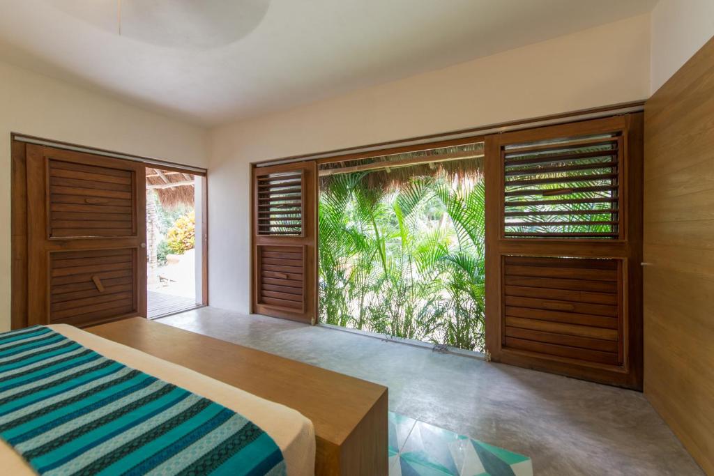 Кровать или кровати в номере Prana Boutique Hotel Tulum