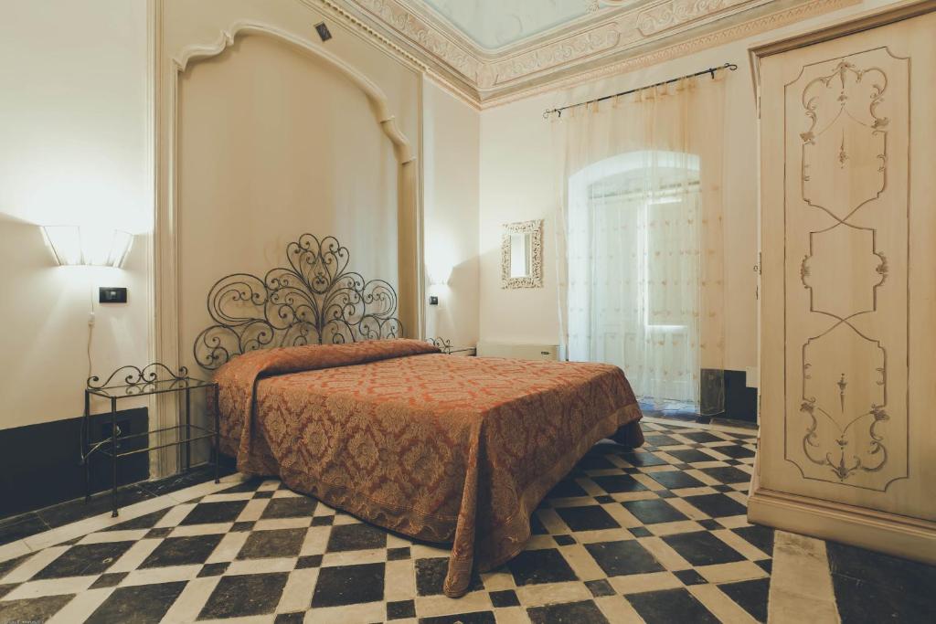 Posteľ alebo postele v izbe v ubytovaní Palazzo Gambuzza
