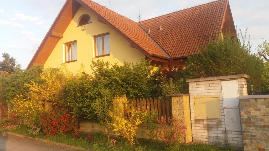 a yellow house with a brown roof at Prague Sweet Home in Prague