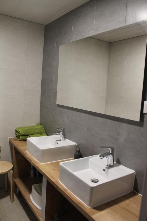 a bathroom with two sinks and a mirror at Au coeur de l'Alsace in Eschau