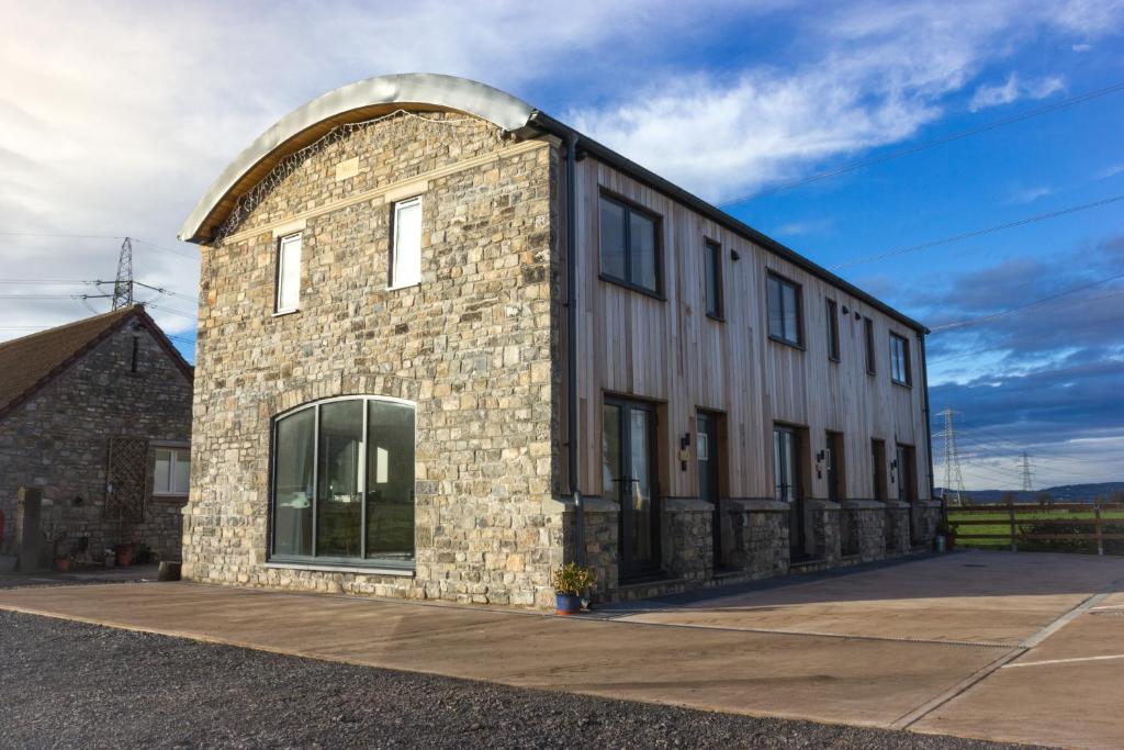 a stone building with an archway on the side of it at The Dutch Barn in Bristol