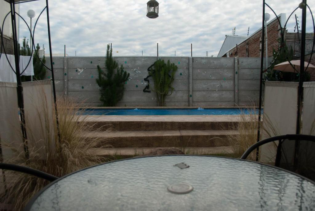 a glass table sitting on top of a patio at Hostel 1760 in Talca