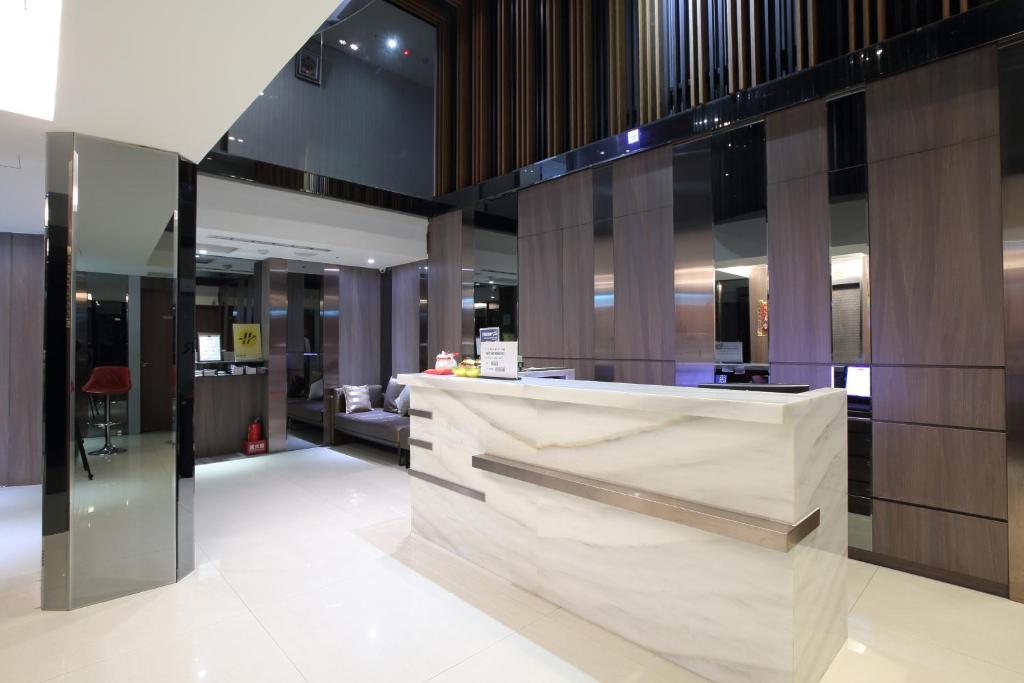a lobby with a marble counter in a building at Guide Hotel Taipei Fuxing North in Taipei