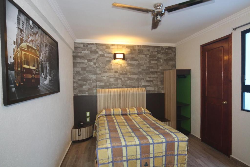 Postel nebo postele na pokoji v ubytování Hotel Plaza Crystal