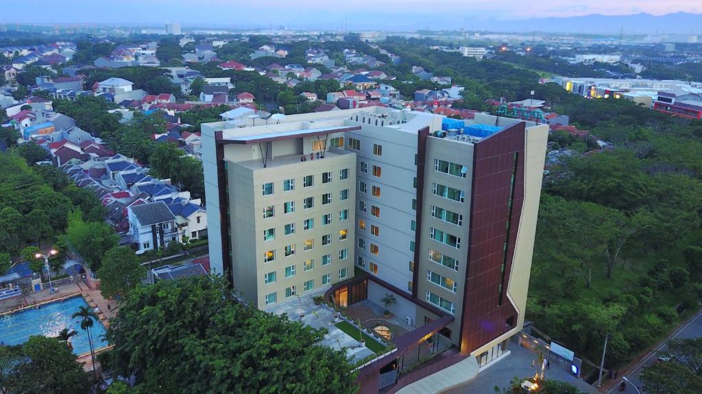 an overhead view of a tall white building at Hotel AYOLA Lippo Cikarang in Cikarang