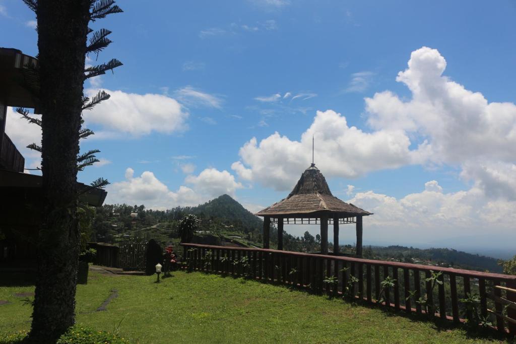 a gazebo on the side of a hill with a view at Sukuh Cottage in Tawangmangu