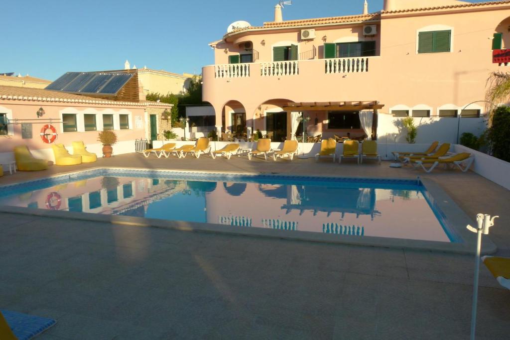 a swimming pool in front of a house at Solar de Mos in Lagos