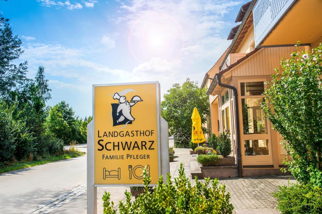 a sign in front of a building at Landgasthof Schwarz in Windsbach