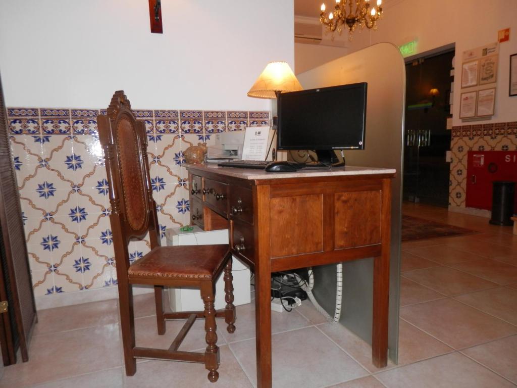 a desk with a computer on it with a chair at Solar de Mos in Lagos