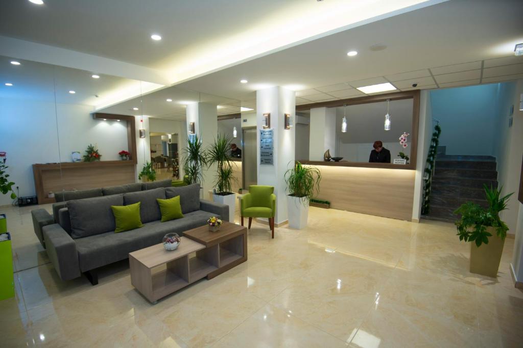 a lobby of a hospital with a couch and a table at Hotel Village in Ohrid