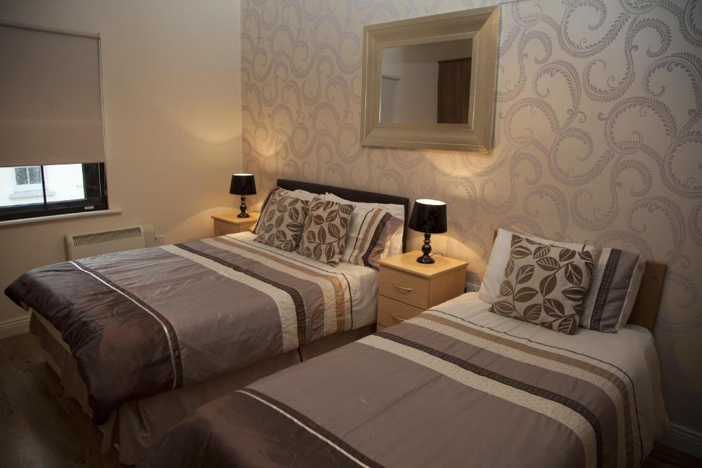 Postel nebo postele na pokoji v ubytování Arch House B&B & Apartments