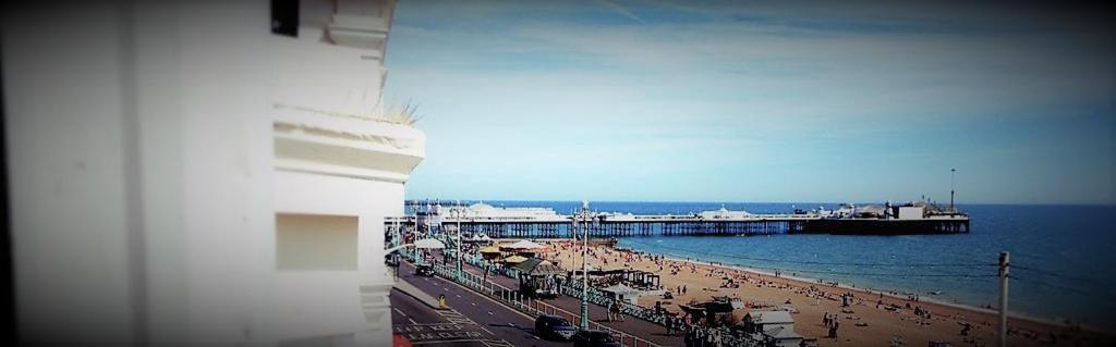 a view of a beach with a pier and the ocean at The View, Brighton in Brighton & Hove