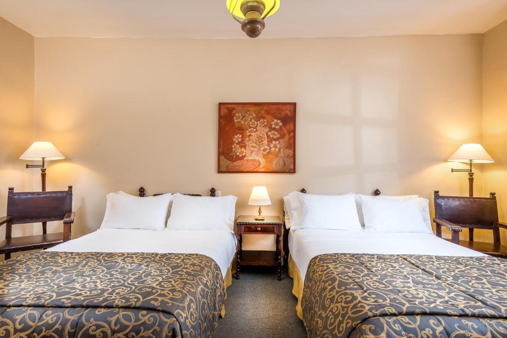 Postel nebo postele na pokoji v ubytování Hotel Dann Monasterio