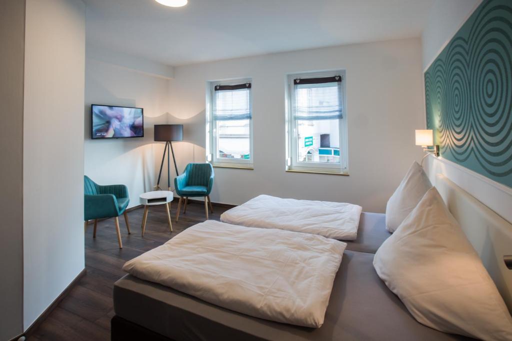 Postel nebo postele na pokoji v ubytování Hotel Zur Alten Börse