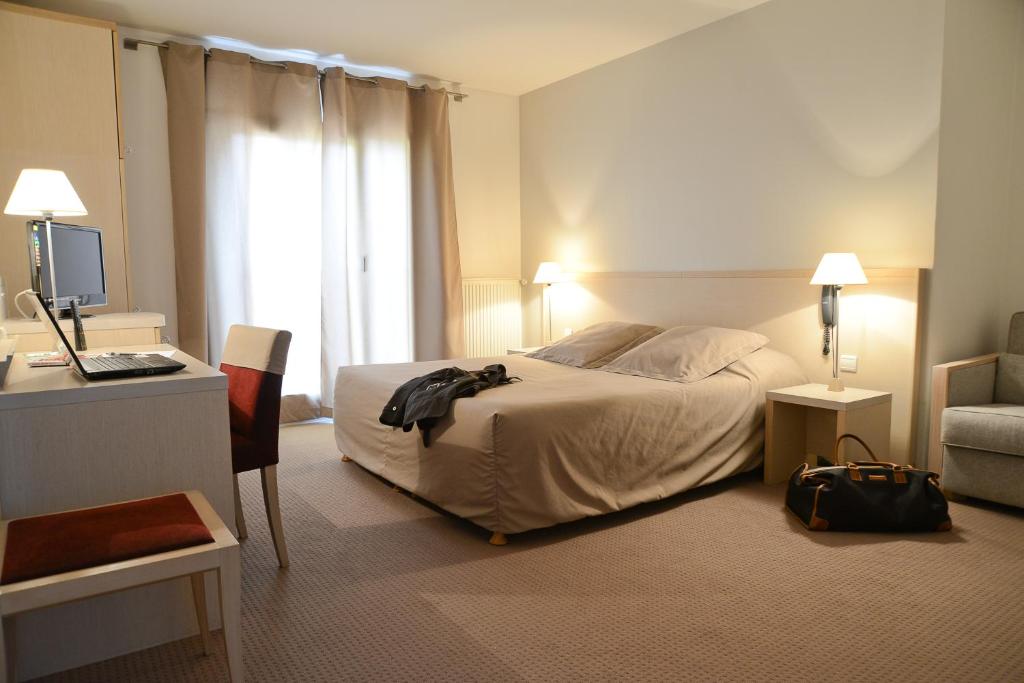 Postel nebo postele na pokoji v ubytování Hotel Restaurant Rolland