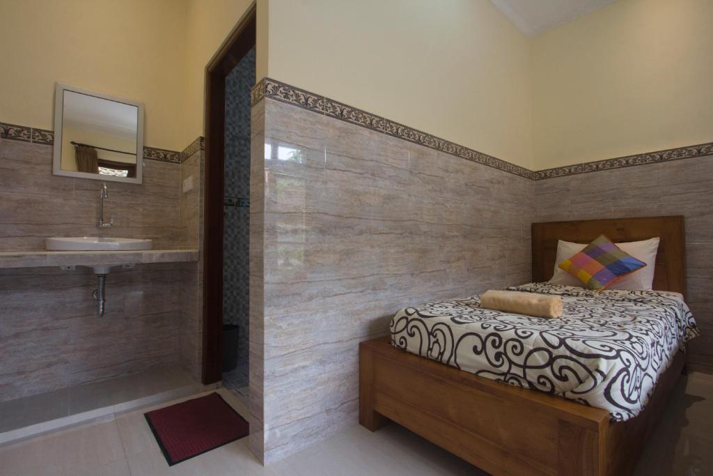 Postel nebo postele na pokoji v ubytování Jepun Bali Ubud Homestay