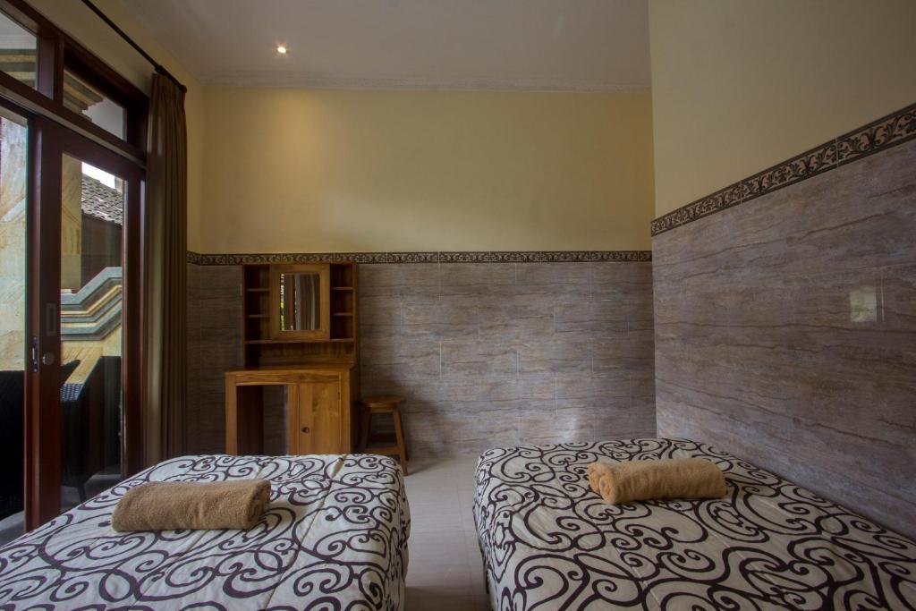Postel nebo postele na pokoji v ubytování Jepun Bali Ubud Homestay