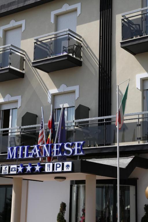 a sign for the meeniss inn in front of a building at Hotel Milanese in Rimini