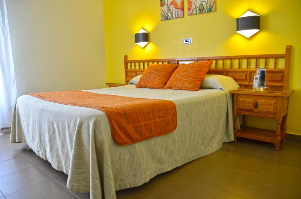 Postel nebo postele na pokoji v ubytování Hotel La Colina