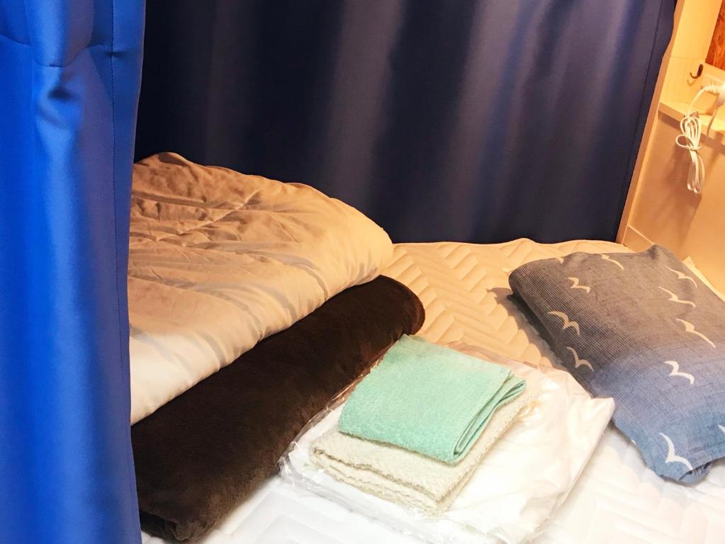 Postel nebo postele na pokoji v ubytování Guest House Kutomare