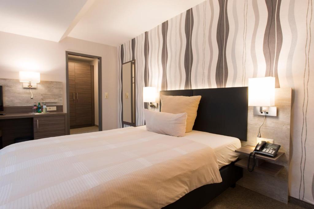 Postel nebo postele na pokoji v ubytování Hotel Westermann