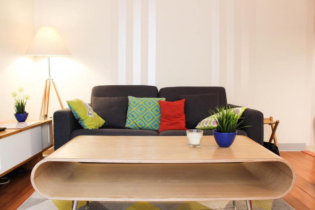 a living room with a couch and a coffee table at Apartment Boulevard Brune in Paris