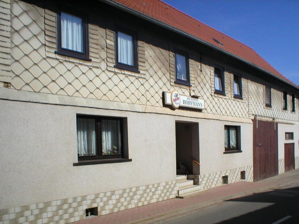 a building with a sign on the side of it at Pension Hoffmann in Trebra