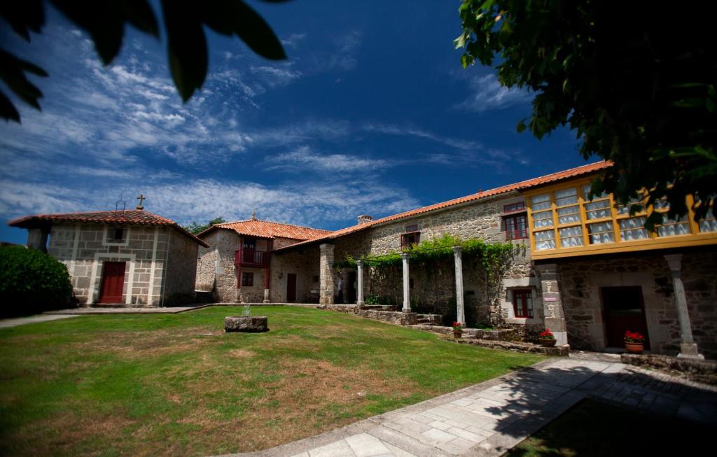 a large building with a yard in front of it at Rectoral de Castillon in Pantón