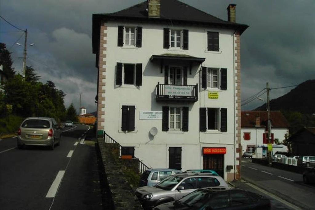 a white building with cars parked on the side of a road at Gite Compostella in Saint-Jean-Pied-de-Port